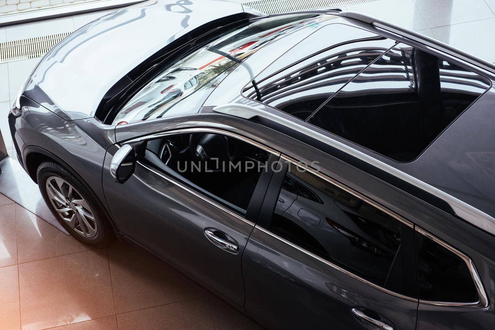 of the car in the spacious showroom with large windows.