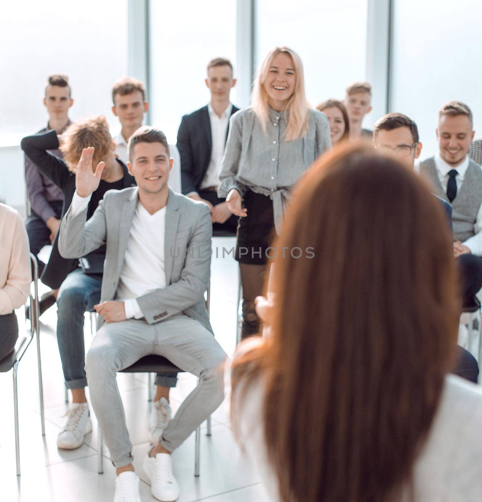 rear view. businesswoman asks questions to the audience during the seminar by asdf