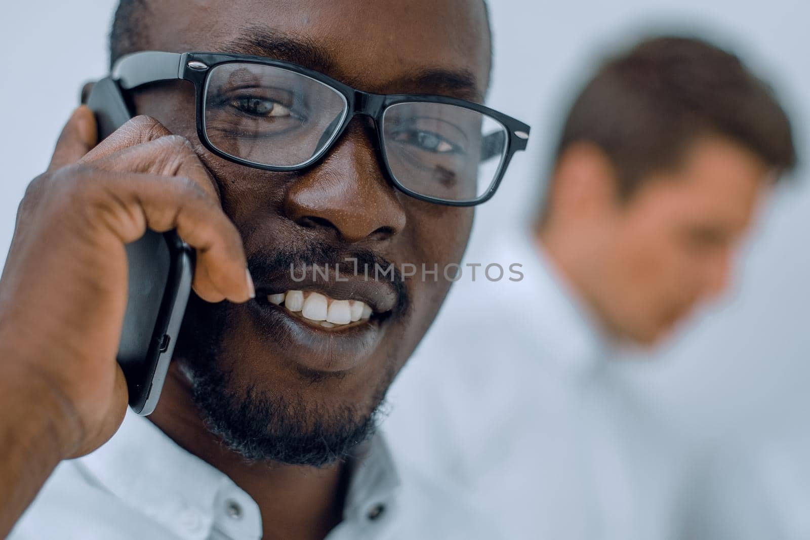 close up.successful businessman talking on mobile phone by asdf