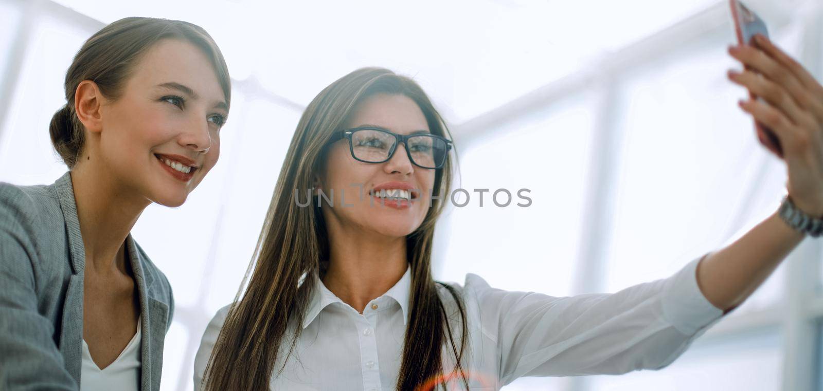 two employees taking a selfie in the workplace.photo with text space