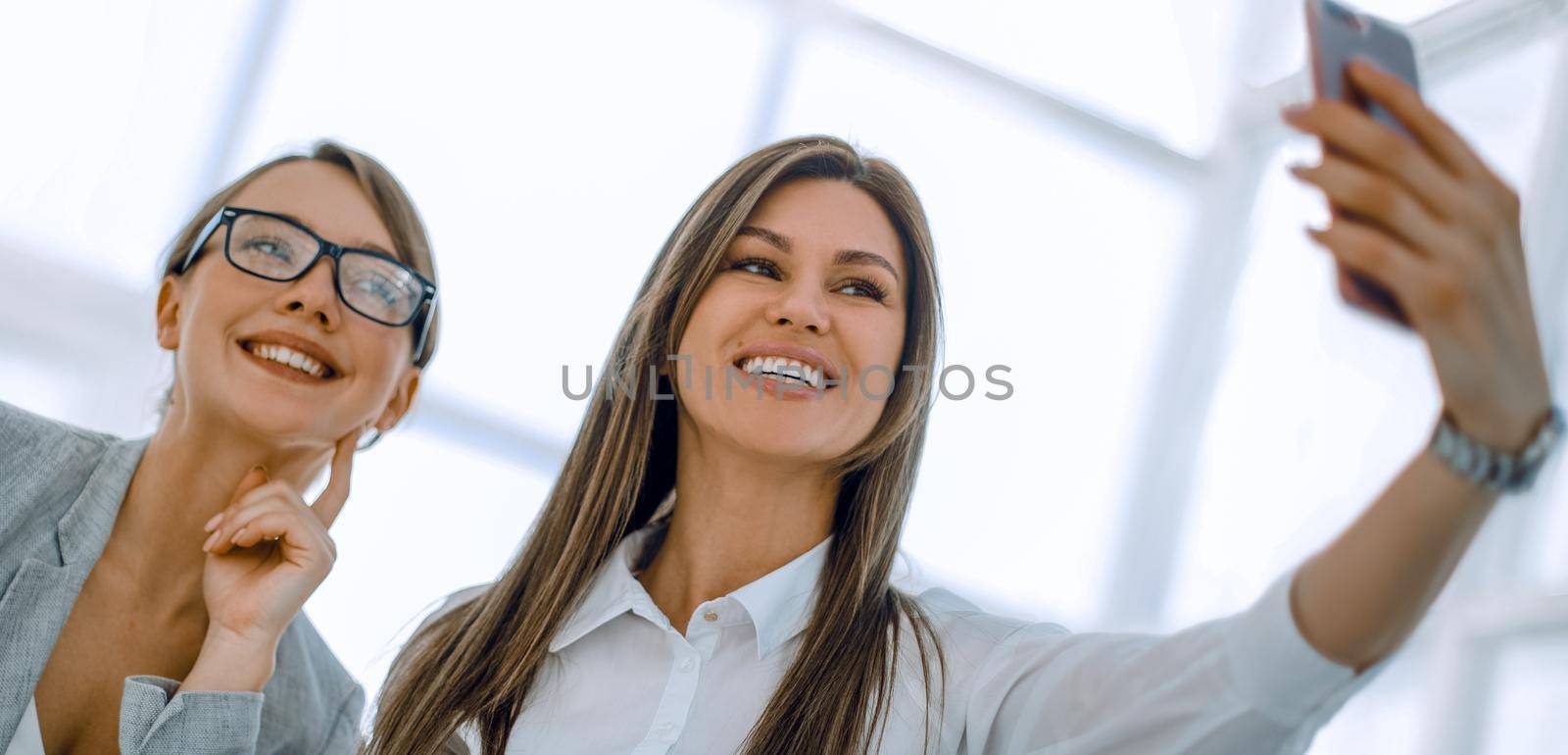 young employees take selfies in the workplace.photo with text space