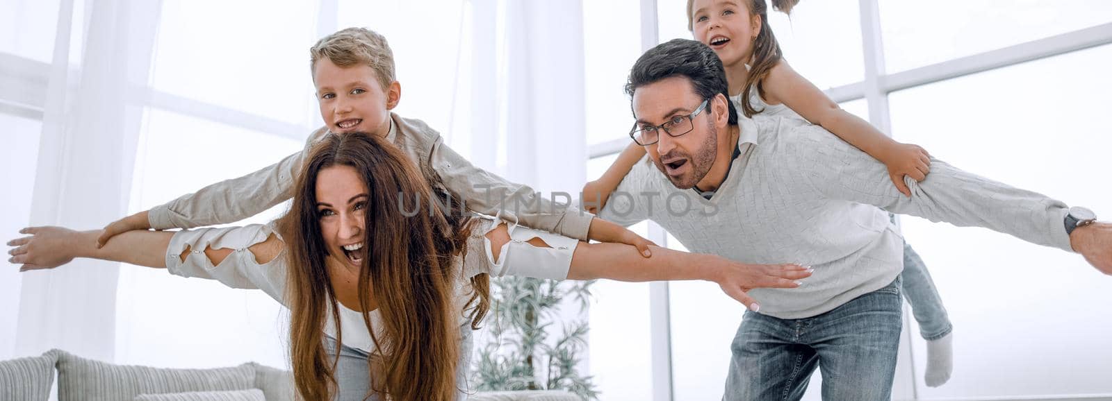 happy parents play with children at home.photo with copy space