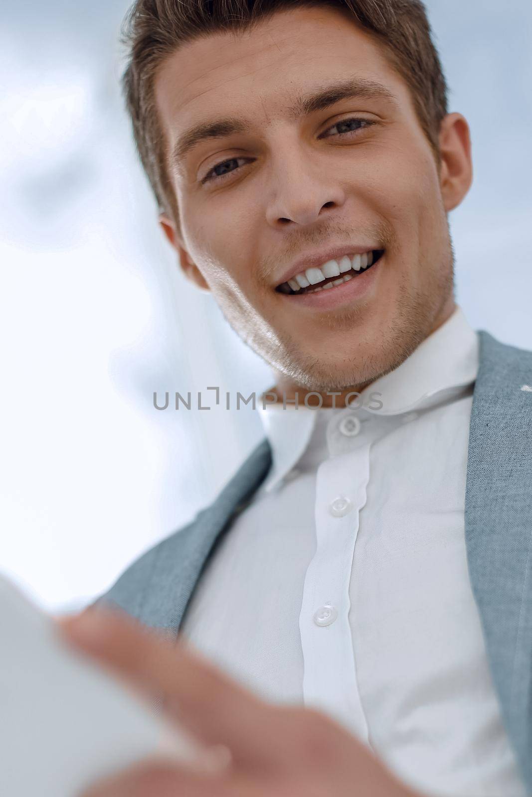 close up.smiling businessman with digital tablet by asdf