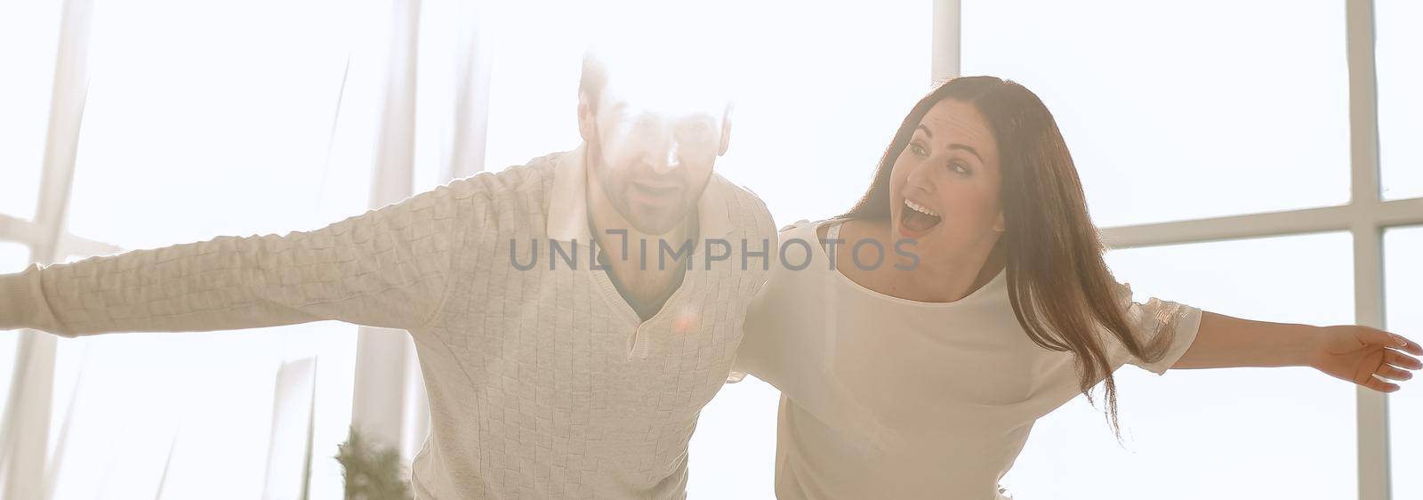 background image of a happy couple dancing in the new apartment.photo with copy space