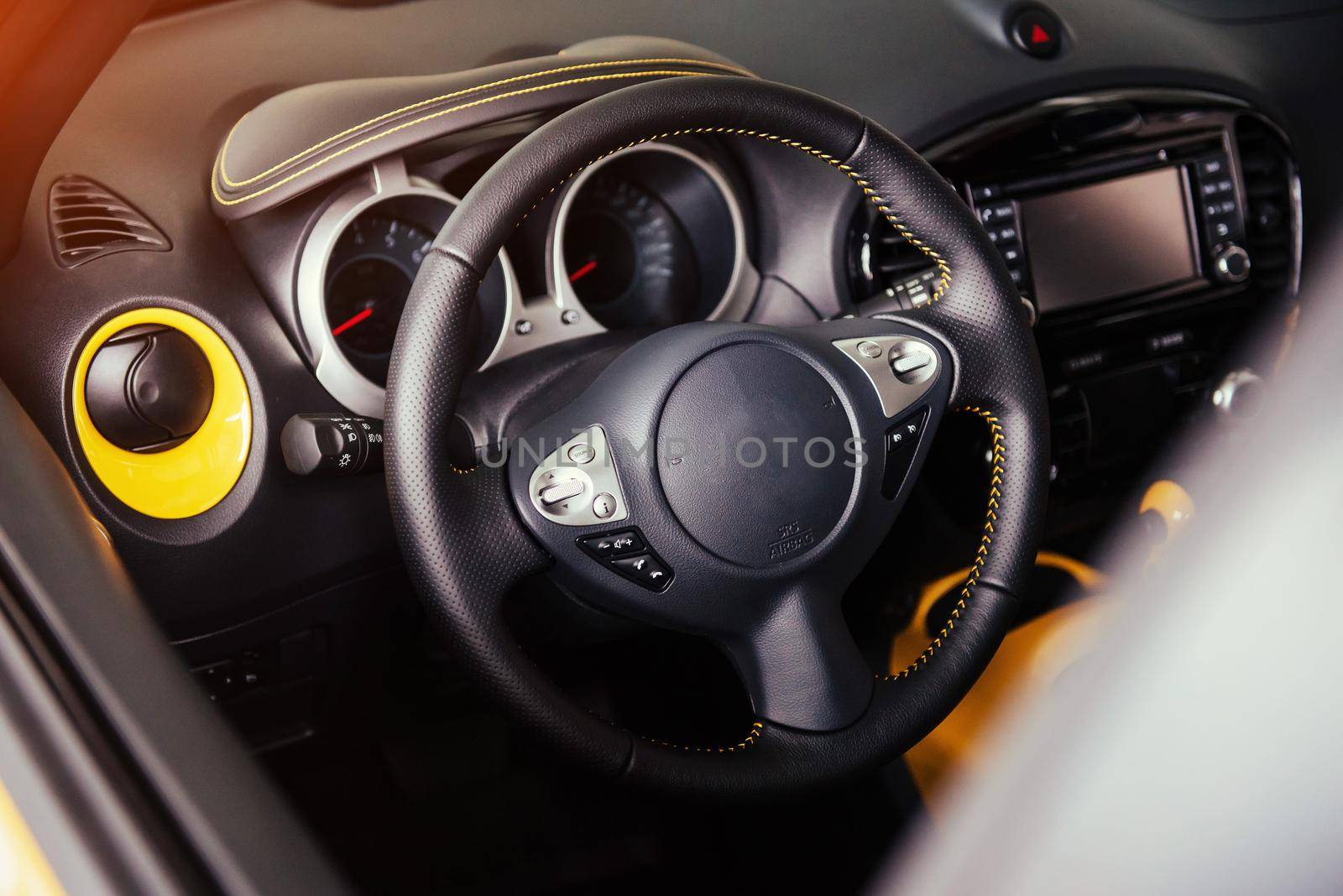 Modern car interior dashboard and steering wheel.