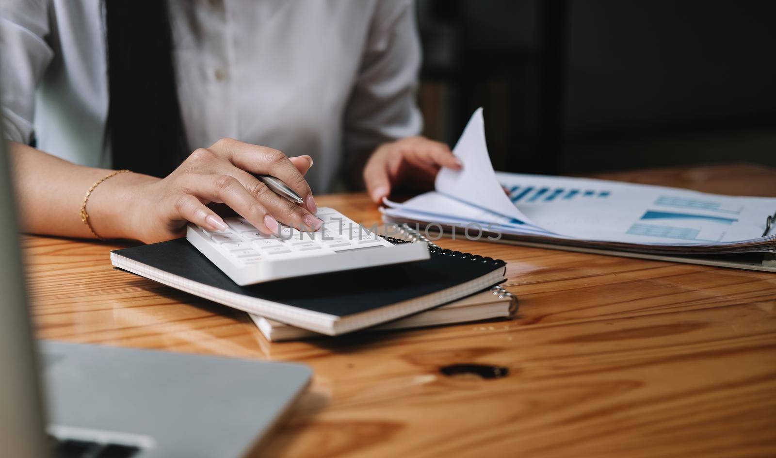 Close up hand of accountant working with computer and calculator for business and financial expense