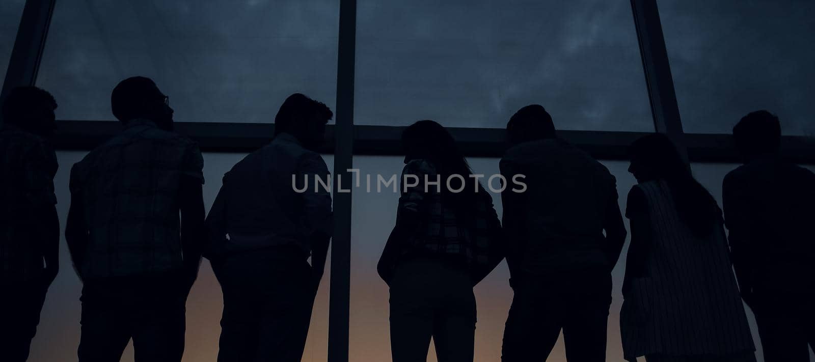 modern business team standing near a large window. by asdf