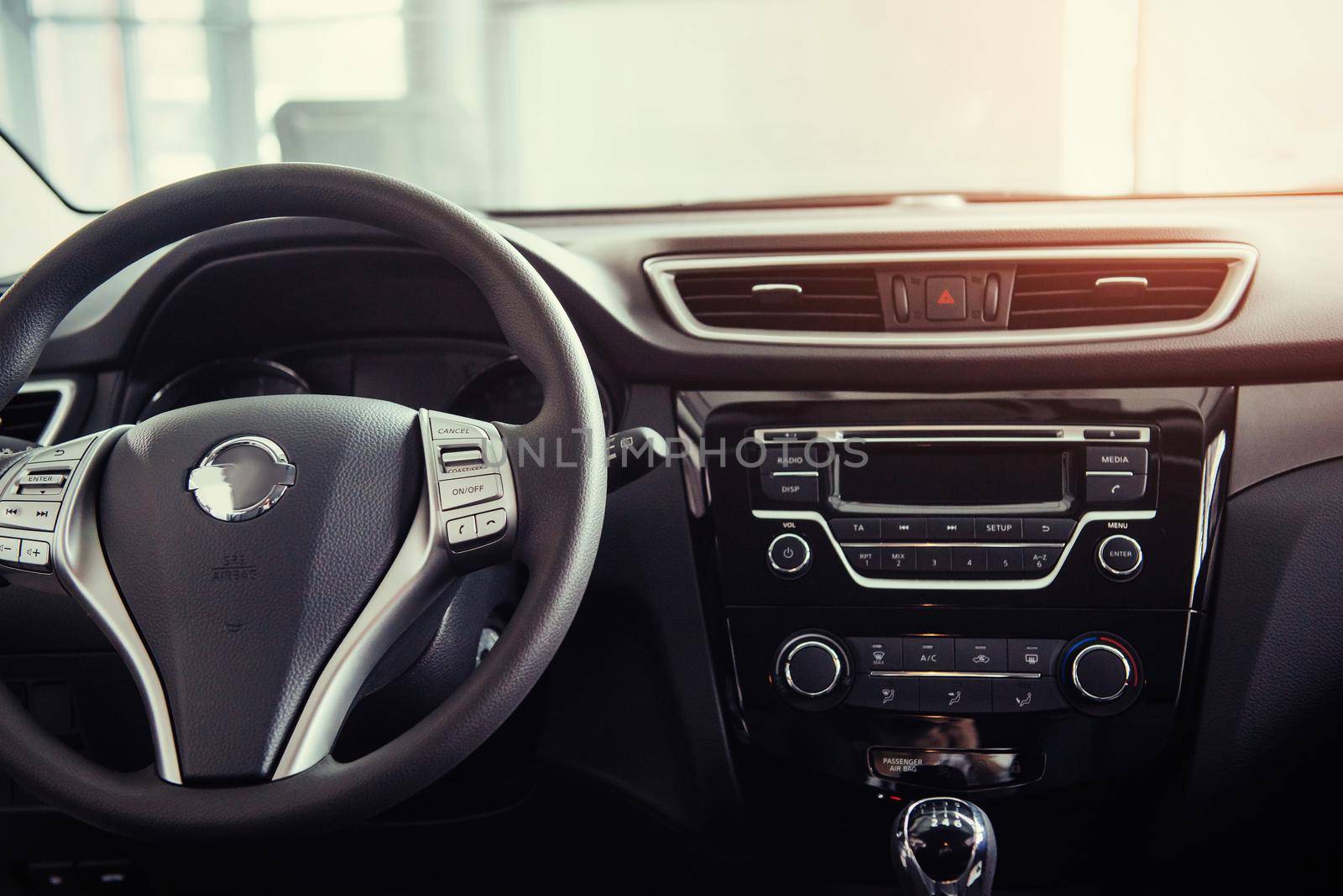 Modern car interior dashboard and steering wheel.