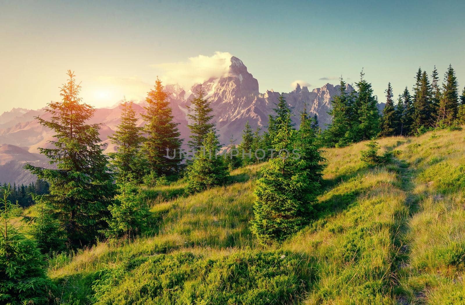 Colorful sky at sunset in the mountains. Fantastic cumulus clouds. Carpathians. Ukraine. Europe