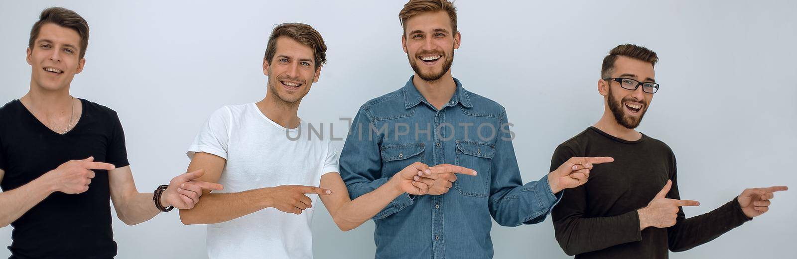 cheerful group of friends showing their fingers to the side .isolated on white background