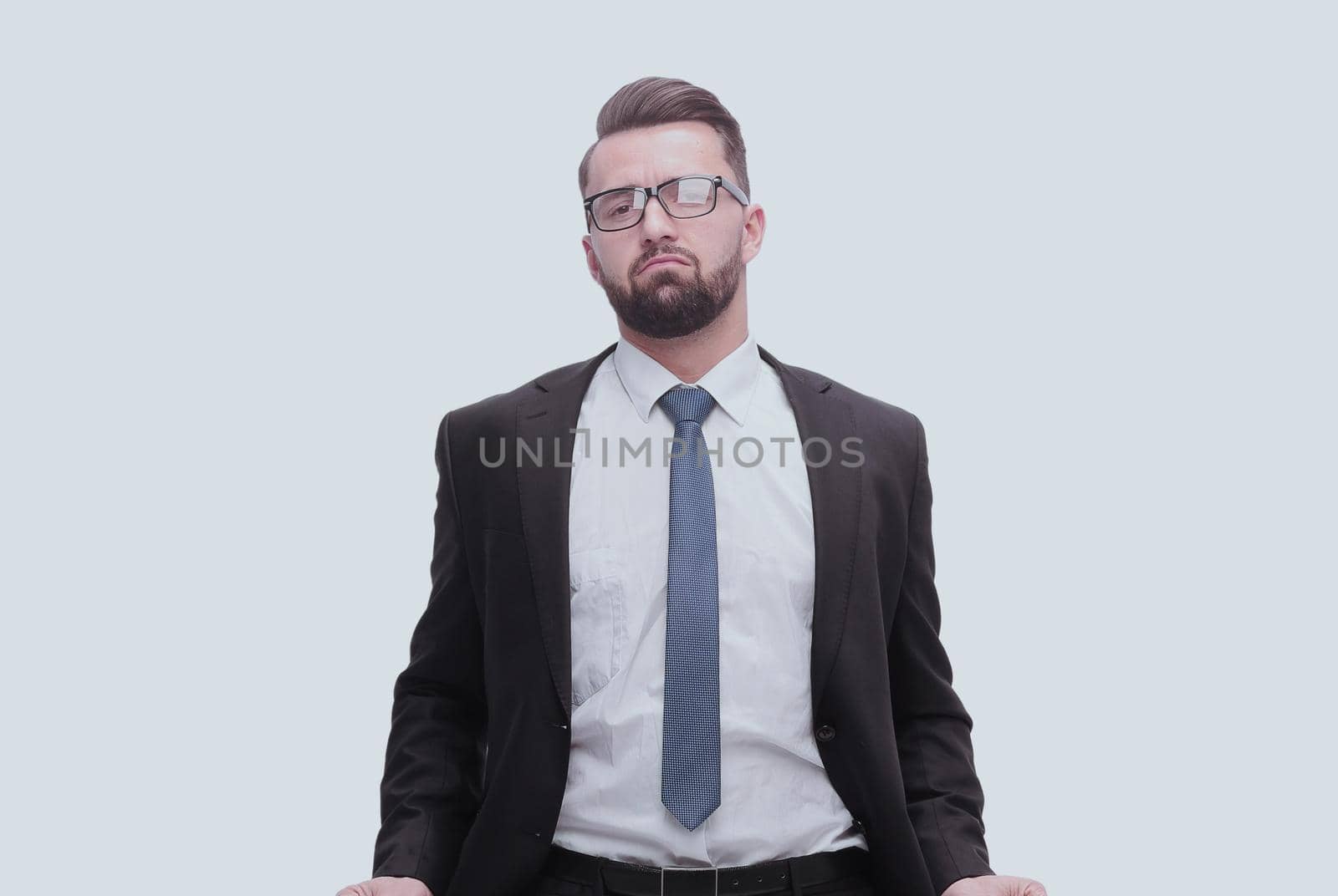 in full growth. frustrated businessman showing his empty pockets. isolated on white background
