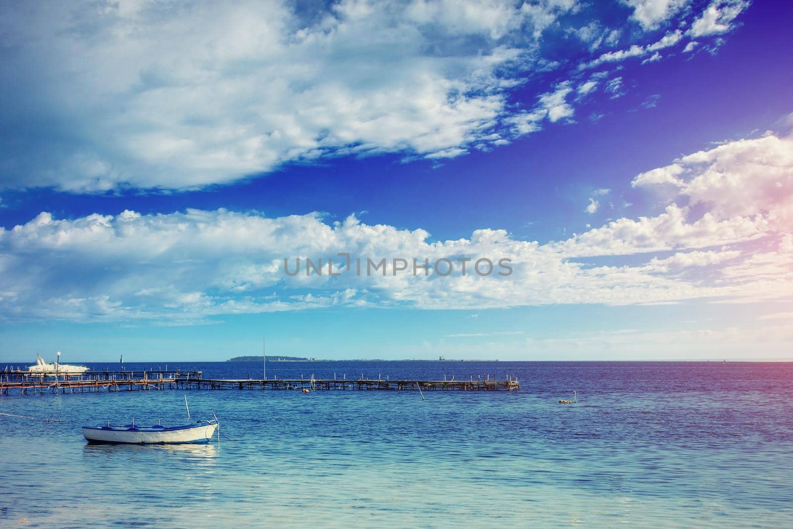 Beautiful summer scene of calm seas and boat.