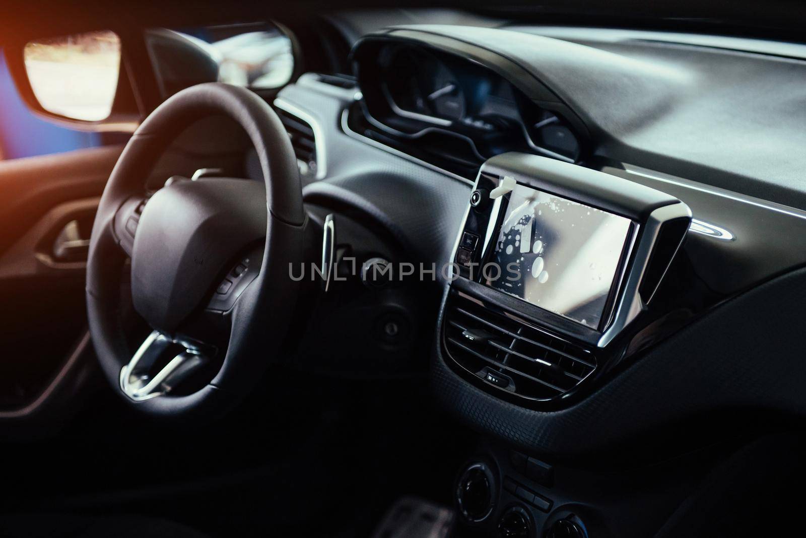 Modern car interior dashboard and steering wheel.