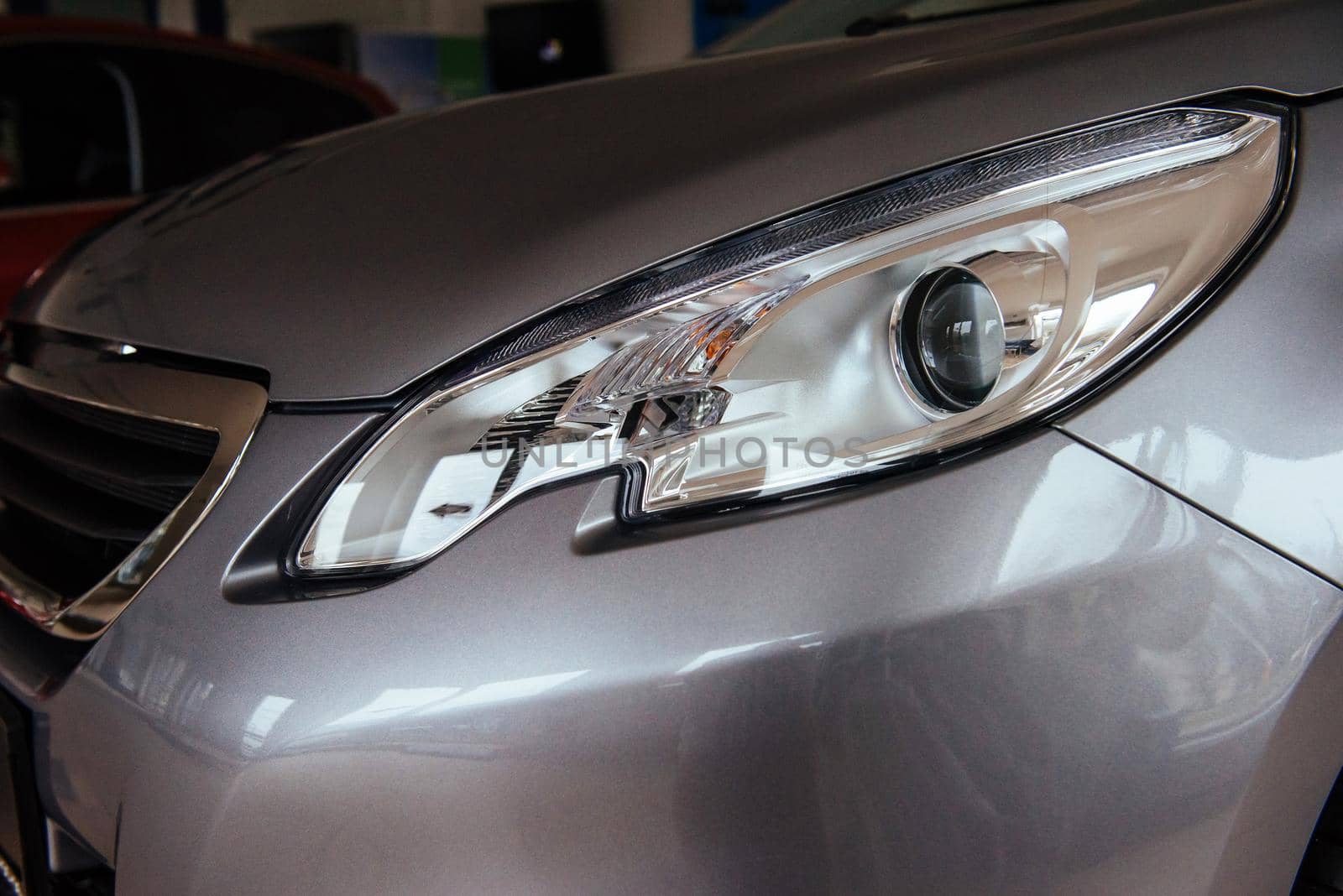 The headlights and the hood of a black sports car.