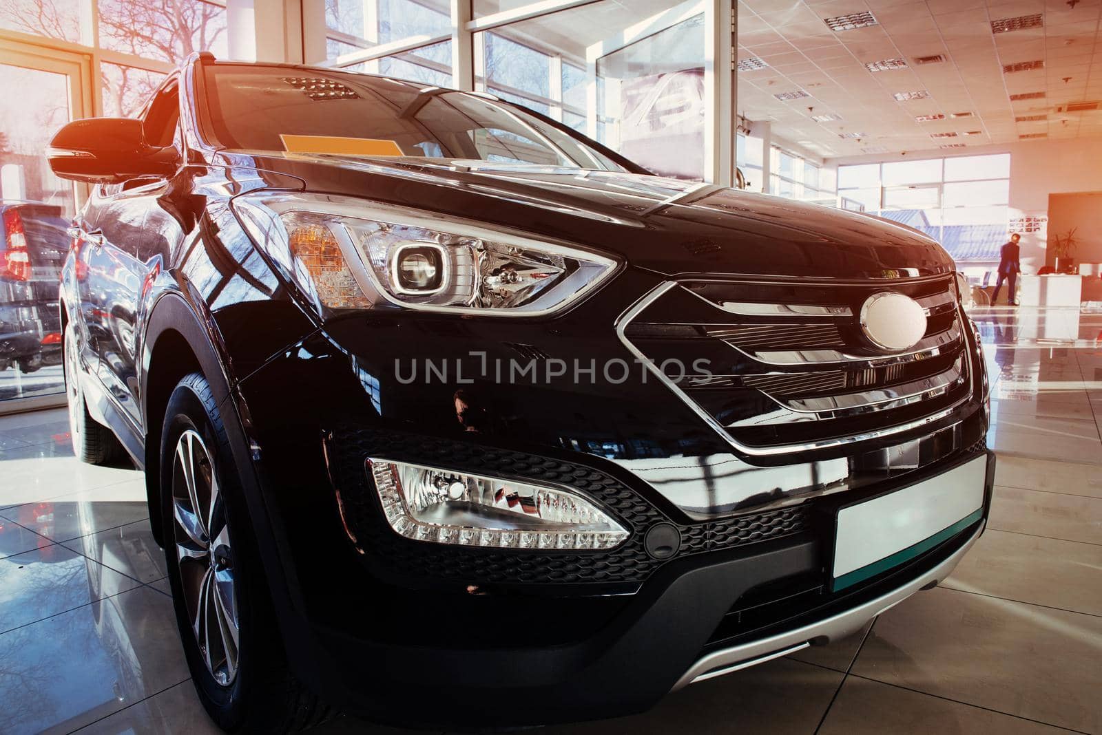 The headlights and the hood of a black sports car