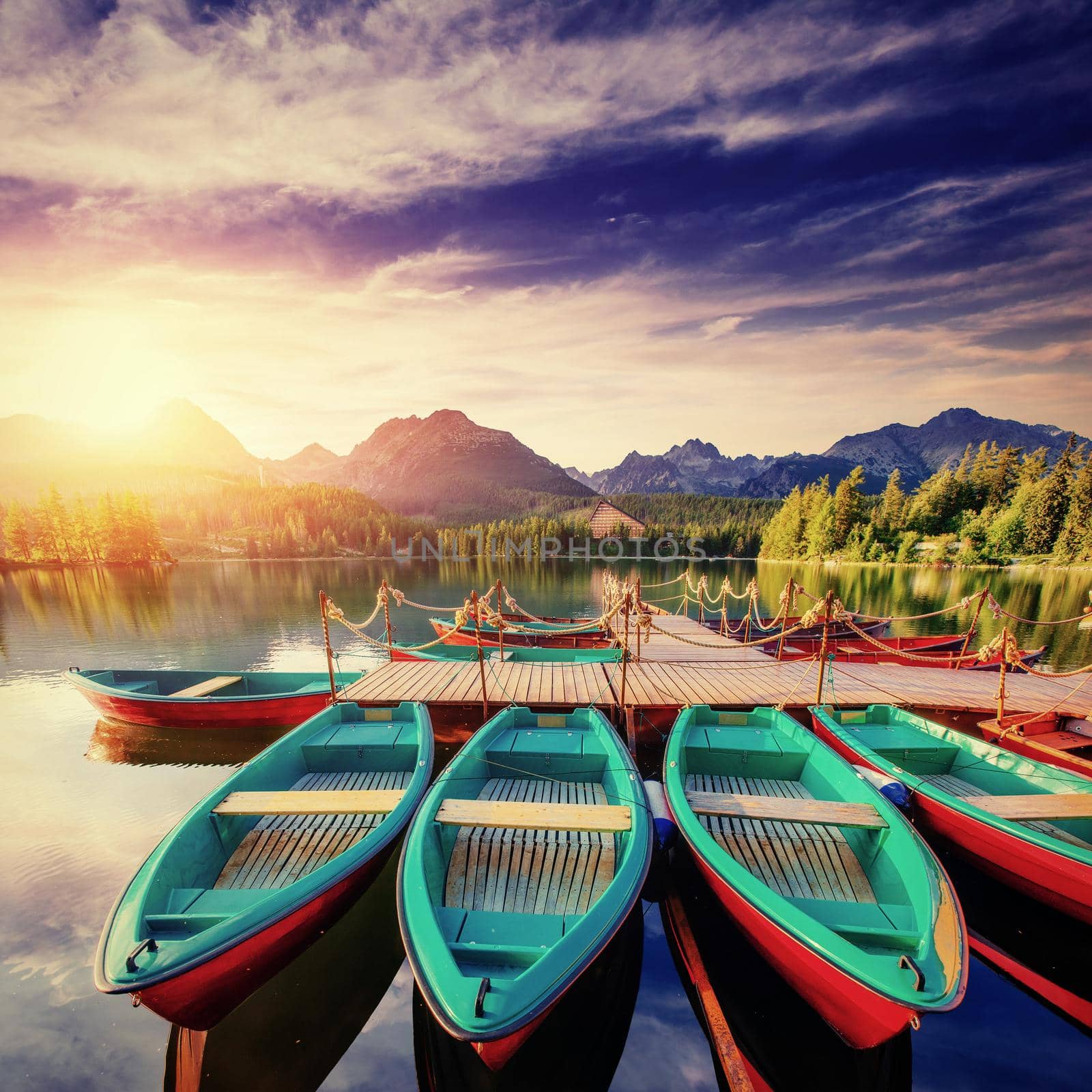 Boat on the dock surrounded mountains. Fantastic Shtrbske Pleso High Tatras. Slovakia, Europe.