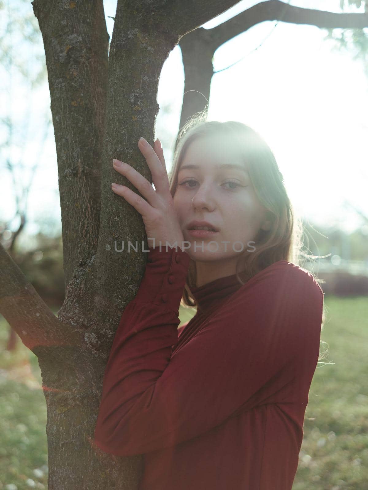 portrait of a girl in backlight in the park in the spring close-up