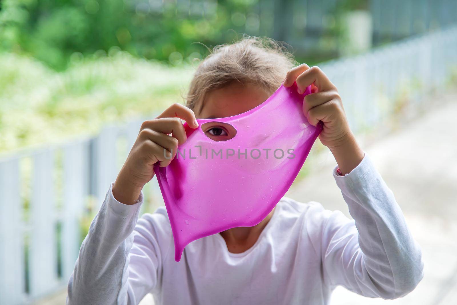 The child plays with a slime. Selective focus.