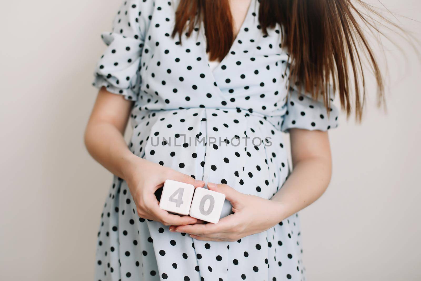40 weeks of pregnancy. Pregnant woman touching belly. Happy woman pregnancy, maternity, body care. Expecting an upcoming baby.