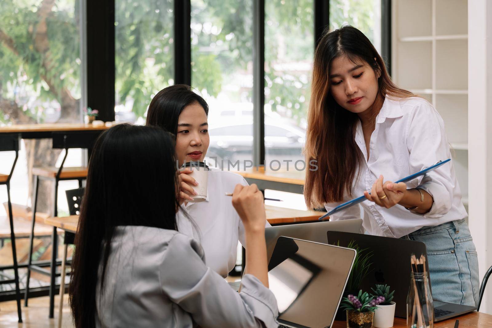 Group of young asian people in smart casual wear discussing business office, Business Team Corporate Organization Meeting Concept. by nateemee