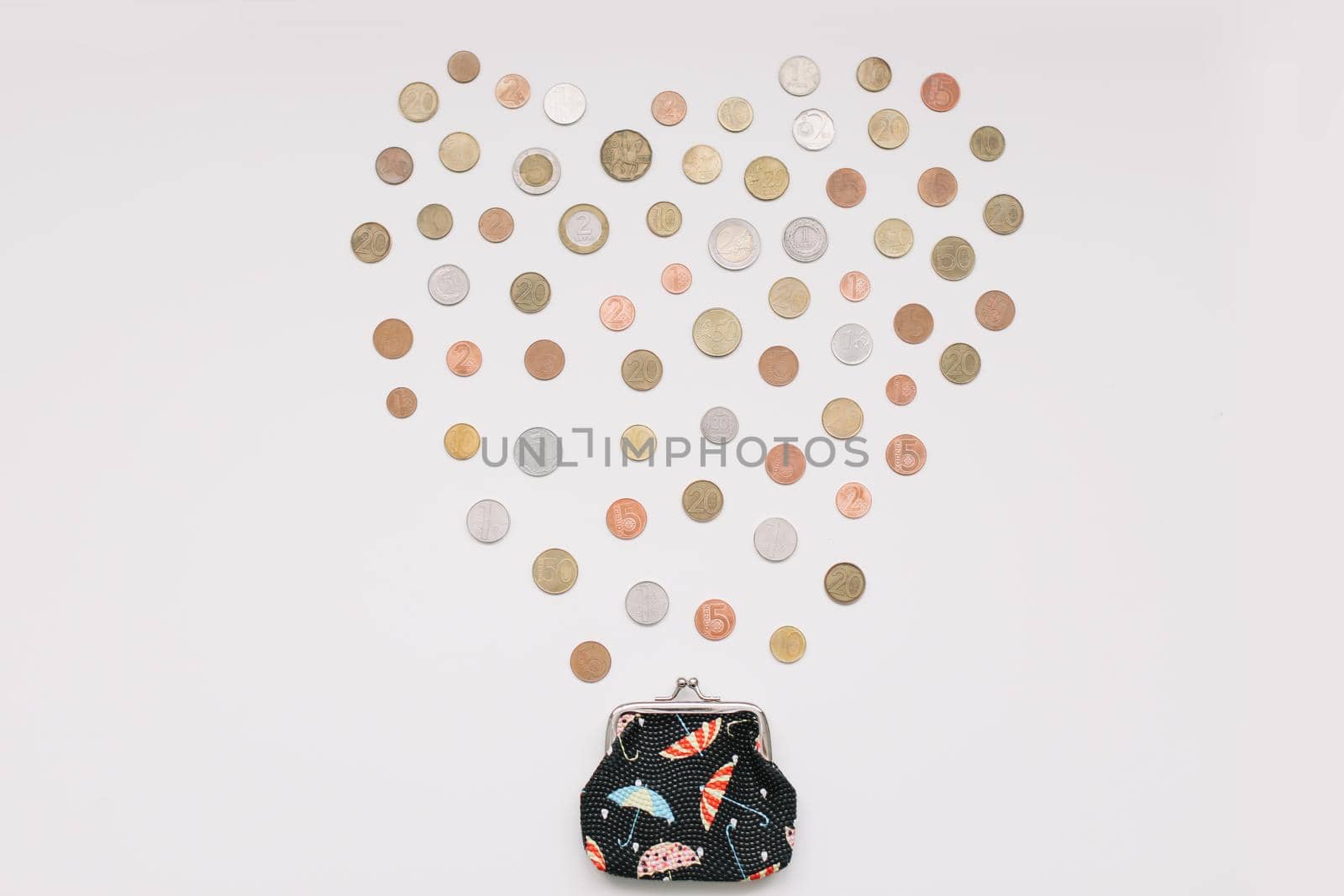 Open purse with different coins isolated on white background top view. Financial crisis, poverty, lack of money