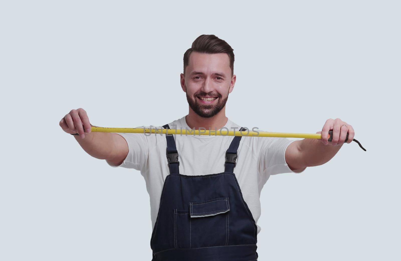 in full growth. smiling man with construction tape measure. isolated on white background