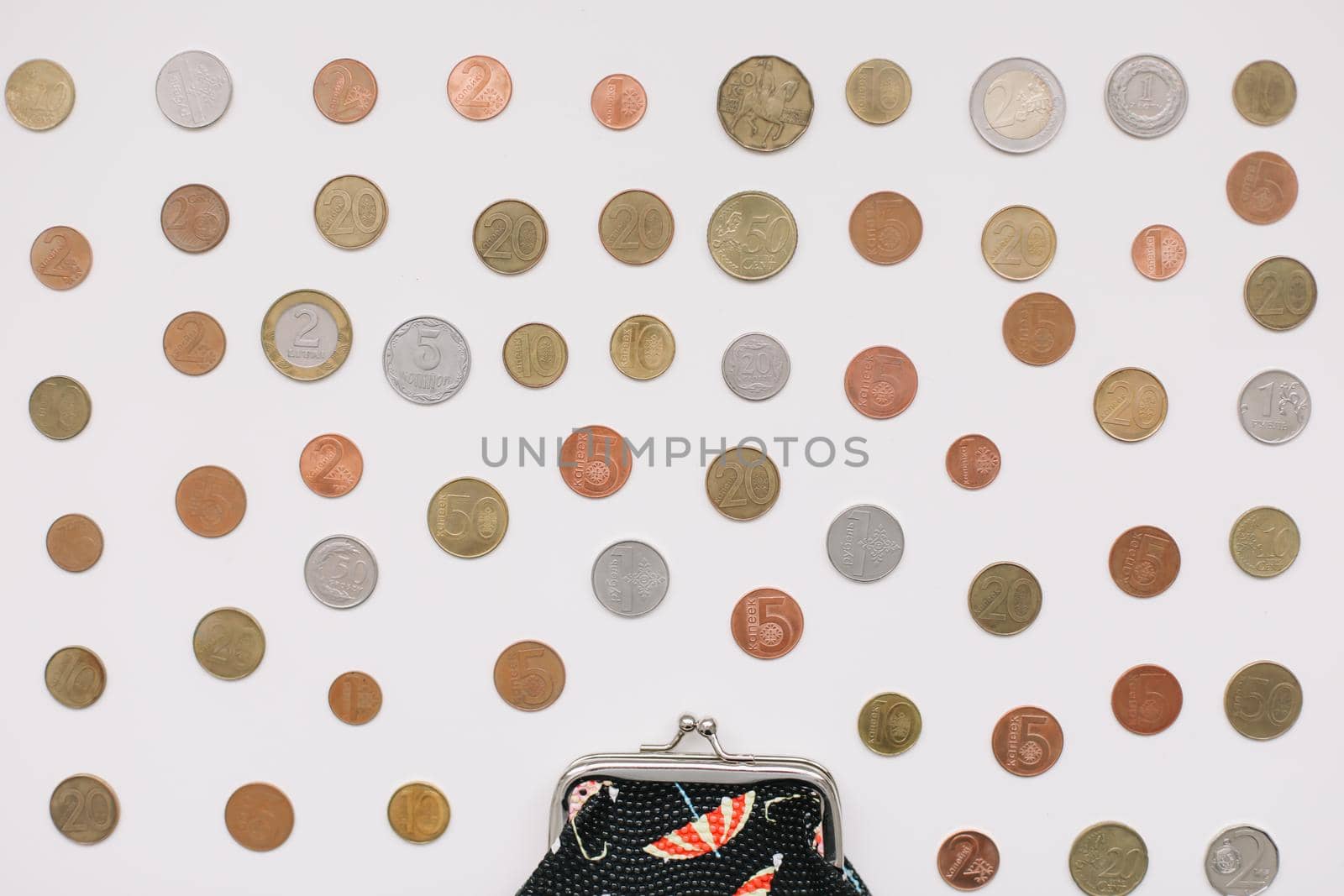 Open purse with different coins isolated on white background top view. Financial crisis, poverty, lack of money