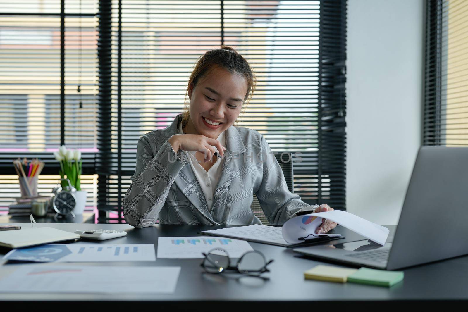 Business asian woman Discussing planning analyzing financial document data charts and graphs in office.