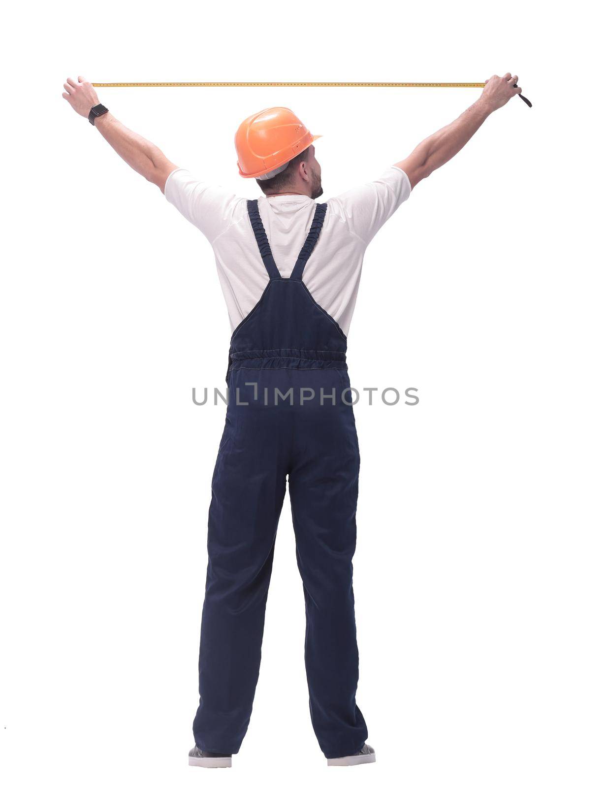 in full growth. man Builder with construction tape measure. isolated on white background