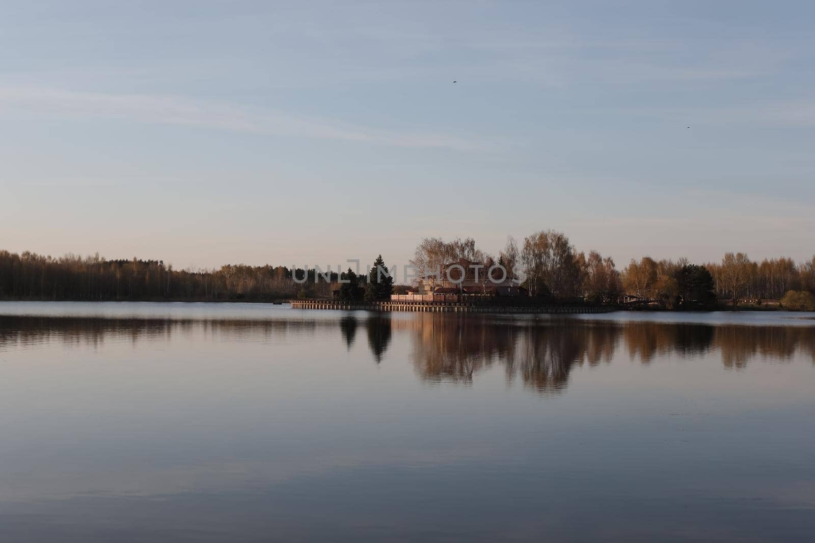 sunset at coast of the lake. Nature landscape. Reflection, blue sky and yellow sunlight. landscape during sunset.