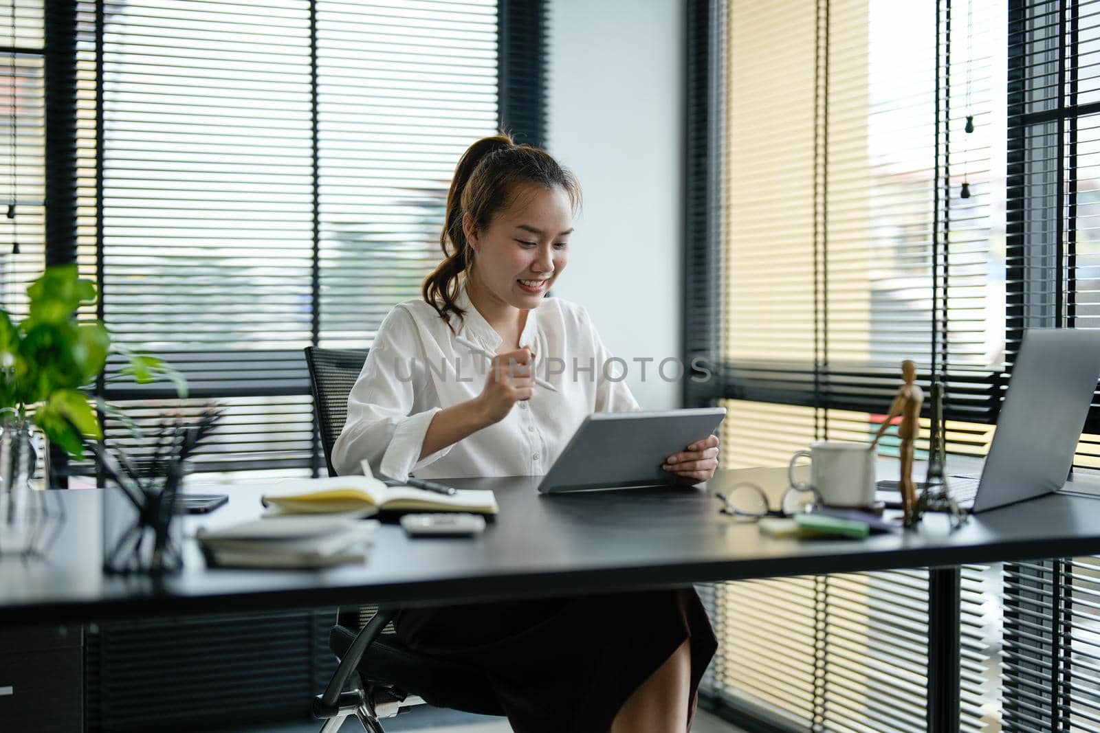 Young asian business woman working on laptop in office.