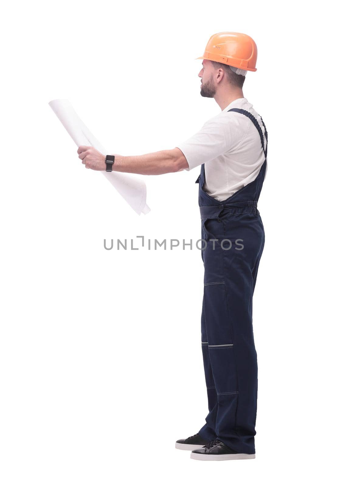 in full growth. competent foreman Builder looking at drawings. isolated on white background