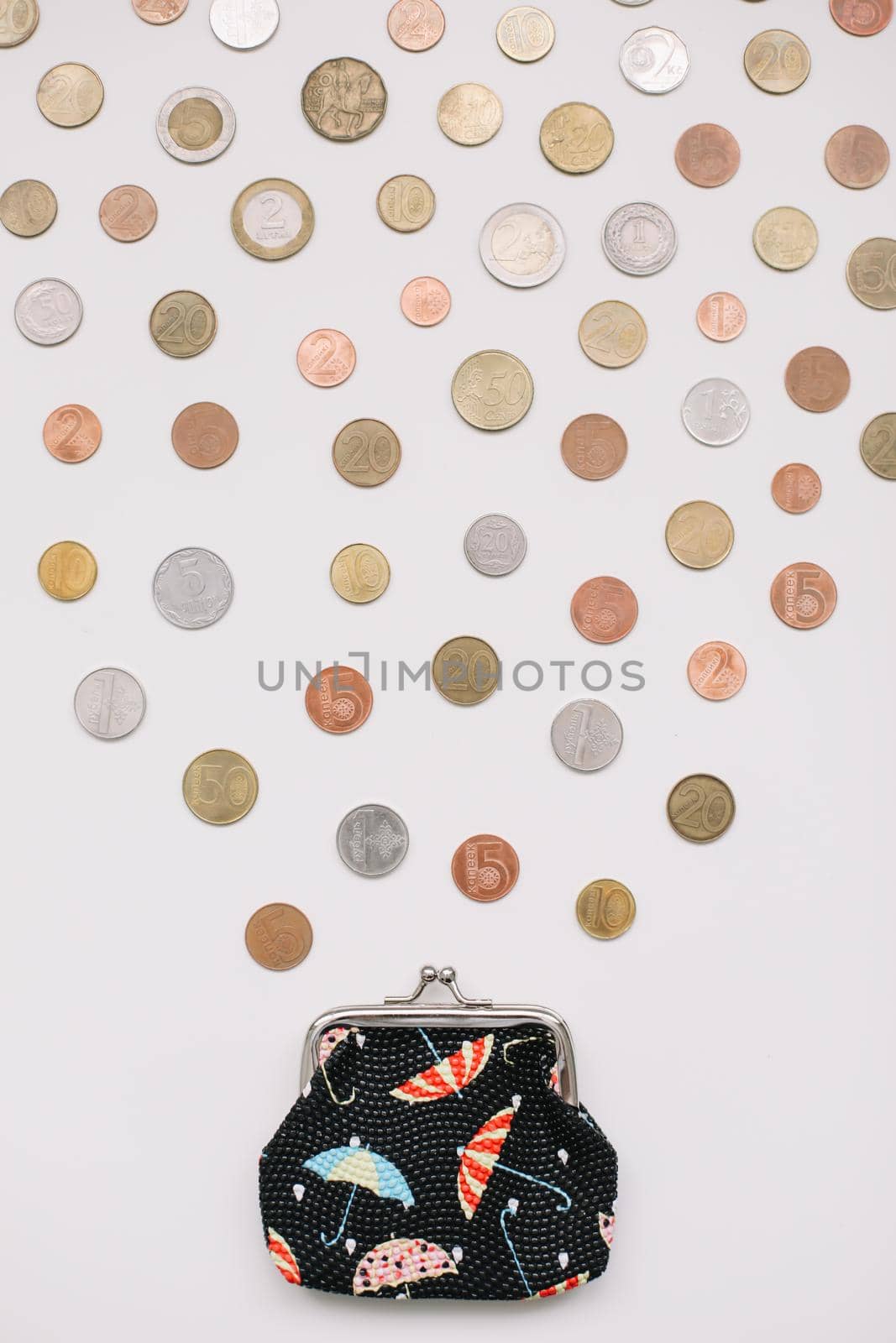 Open purse with different coins isolated on white background top view. Financial crisis, poverty, lack of money