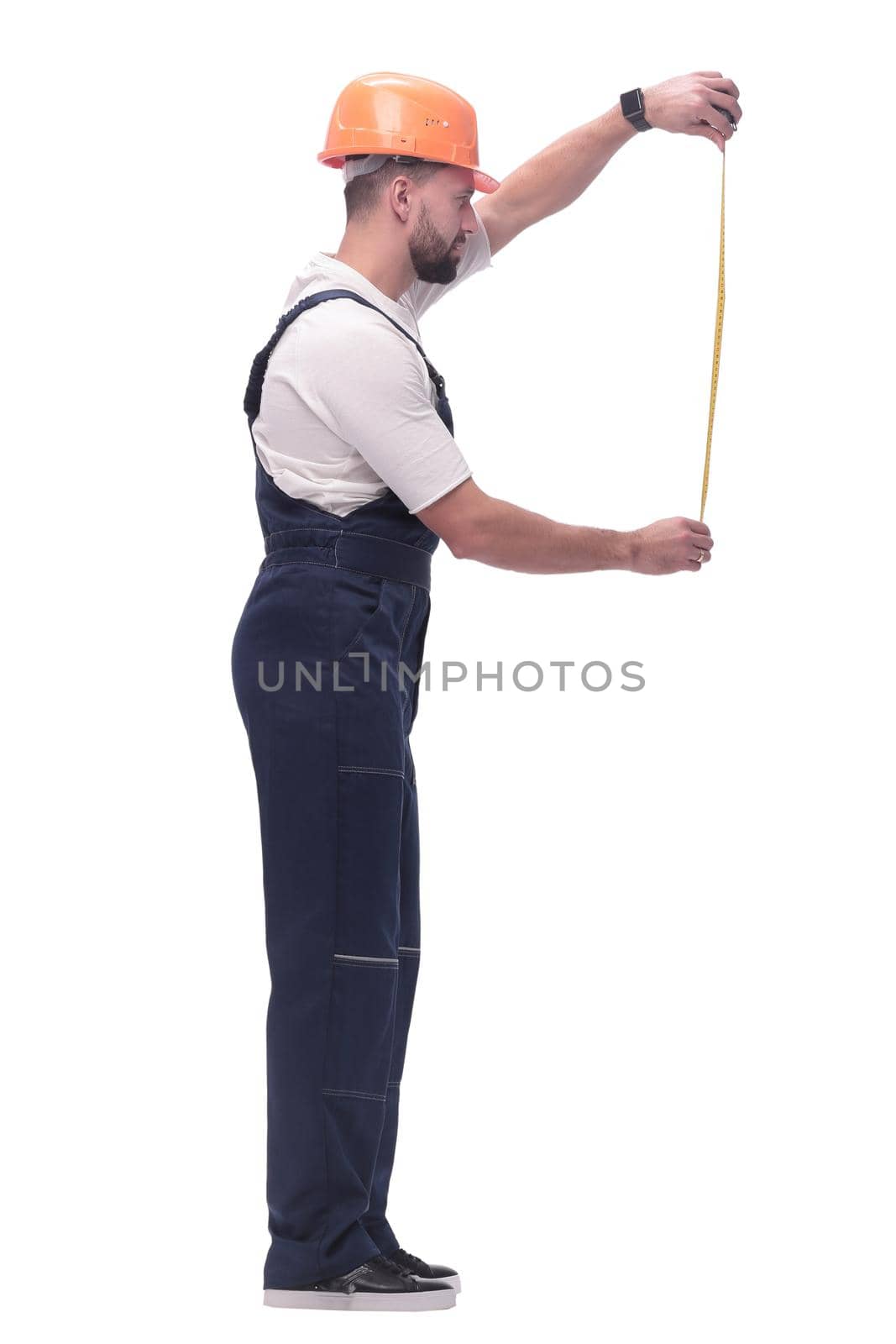 in full growth. man Builder with construction tape measure. isolated on white background