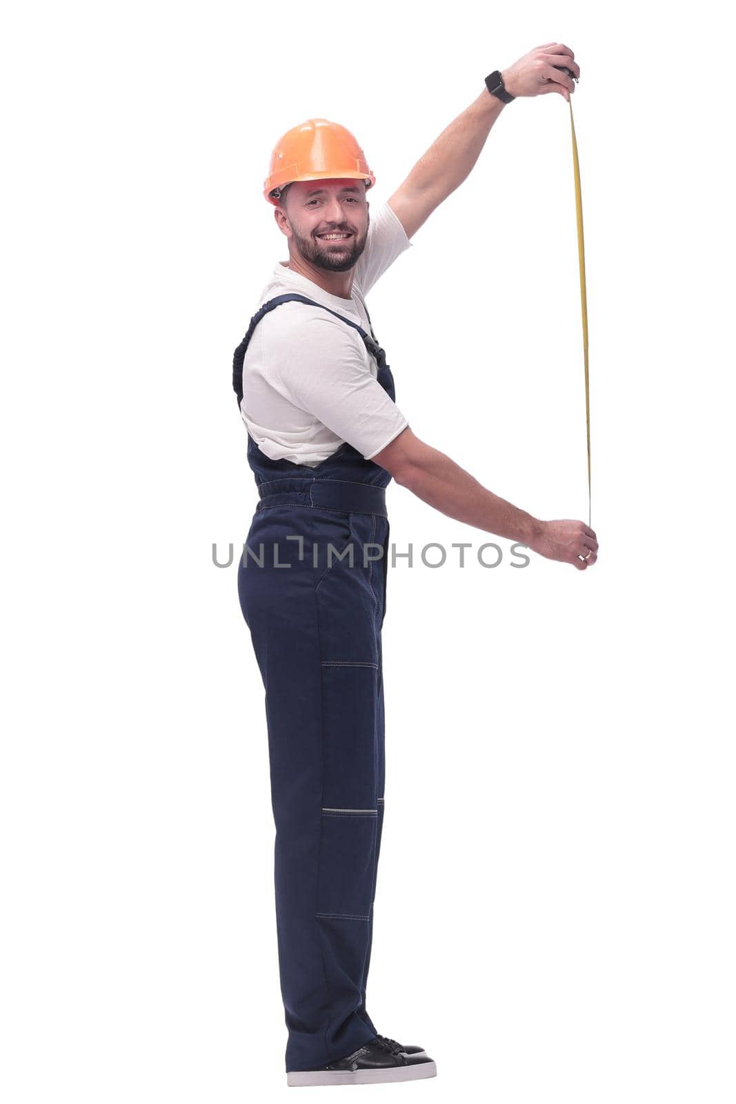 in full growth. man Builder with construction tape measure. isolated on white background