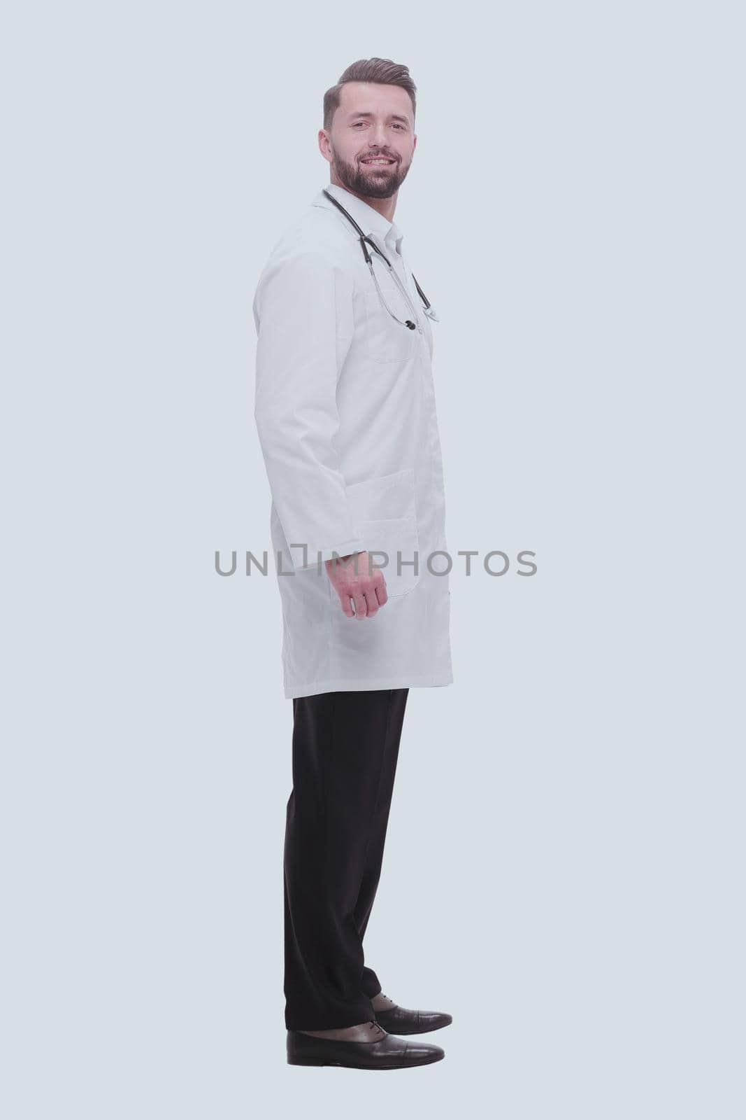 side view. smiling pediatrician doctor with stethoscope .isolated on white