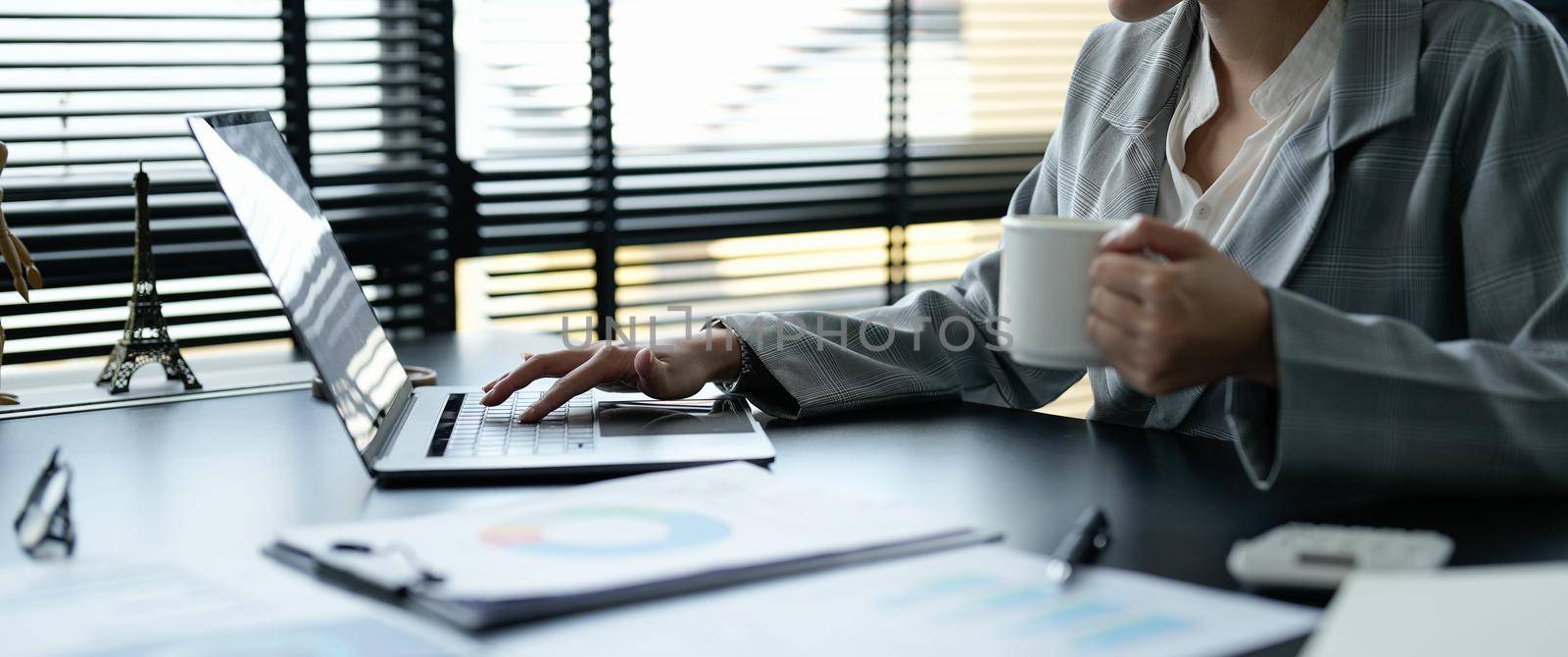 Close up business asian woman working about financial with business report and calculator.financial or accounting concept