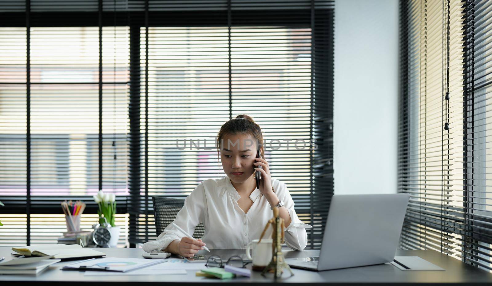 Portrait asian business woman making a phone call and smiling while working it office.
