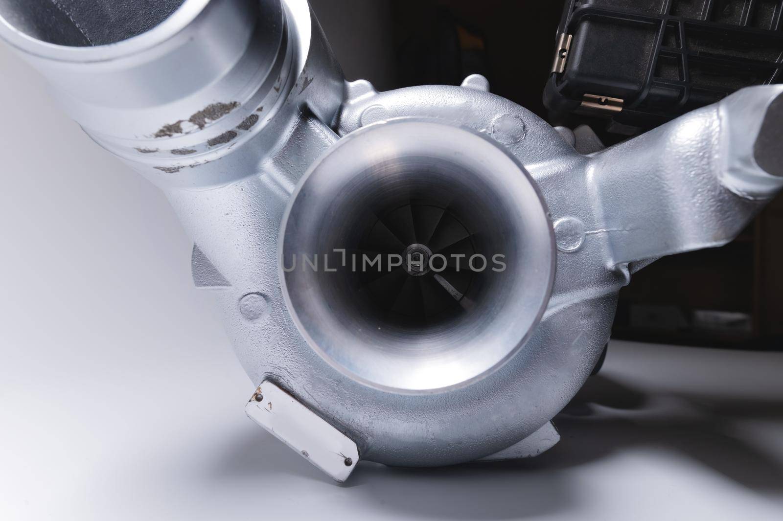 New turbocharger with aluminum cold section. on a gray contrasting background. car engine turbocharger. spare parts by yanik88