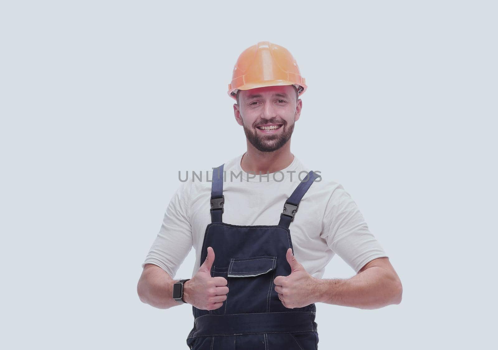 smiling man in overalls showing thumbs up . isolated on white by asdf