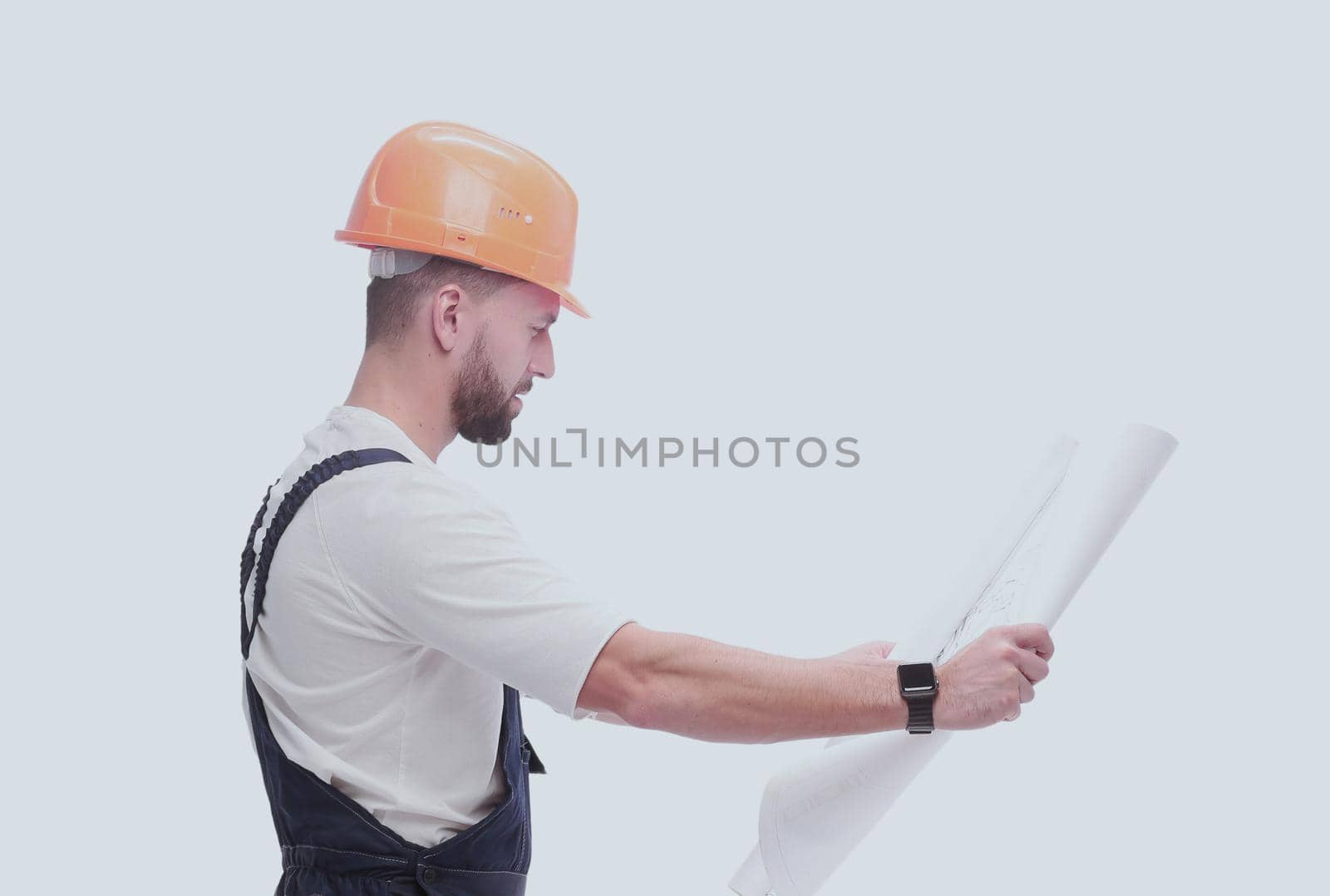 competent foreman Builder looking at drawings. isolated on white by asdf