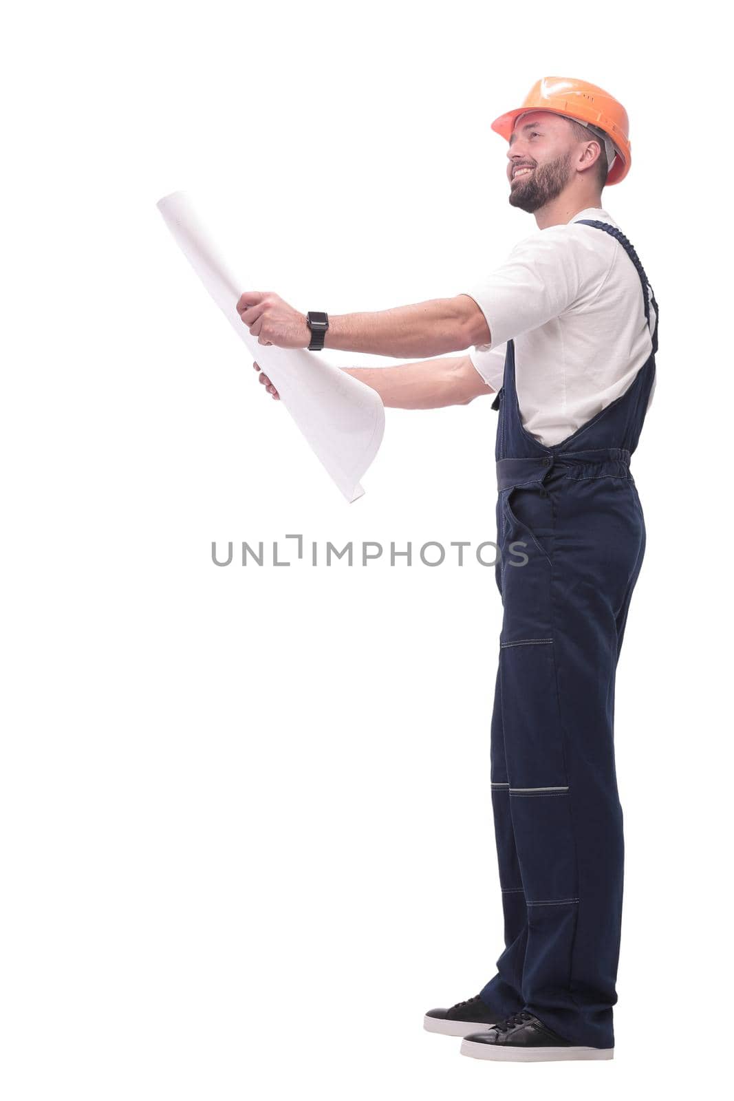 in full growth. competent foreman Builder looking at drawings. isolated on white background