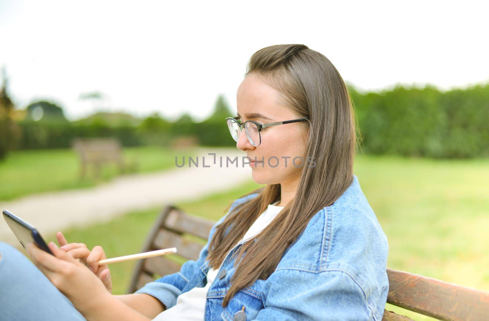 young beautiful student girl is learning outdoor. High quality photo