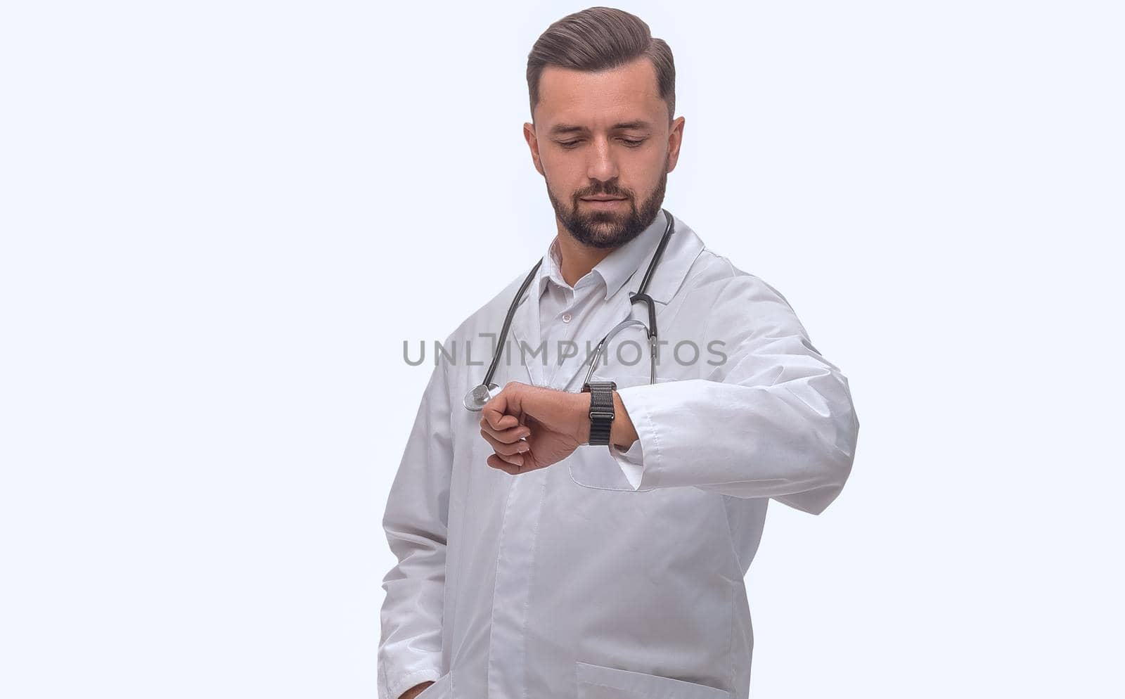 in full growth. medical doctor looking at his wrist watch by asdf