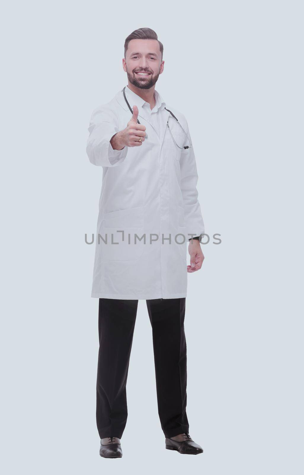 smiling medical professional showing thumbs up .isolated on white by asdf