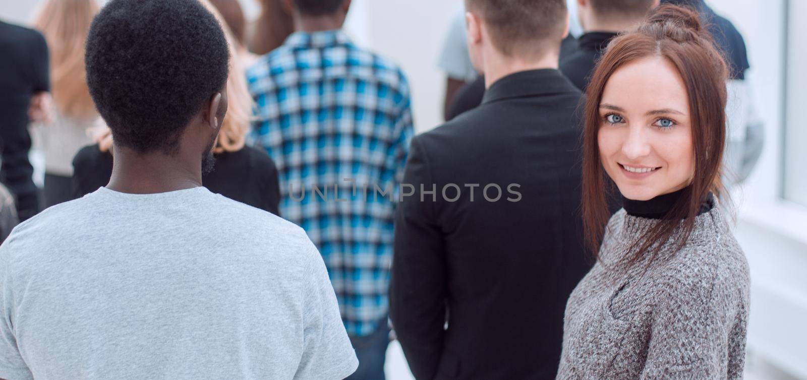 young woman standing among a group of diverse young people by asdf
