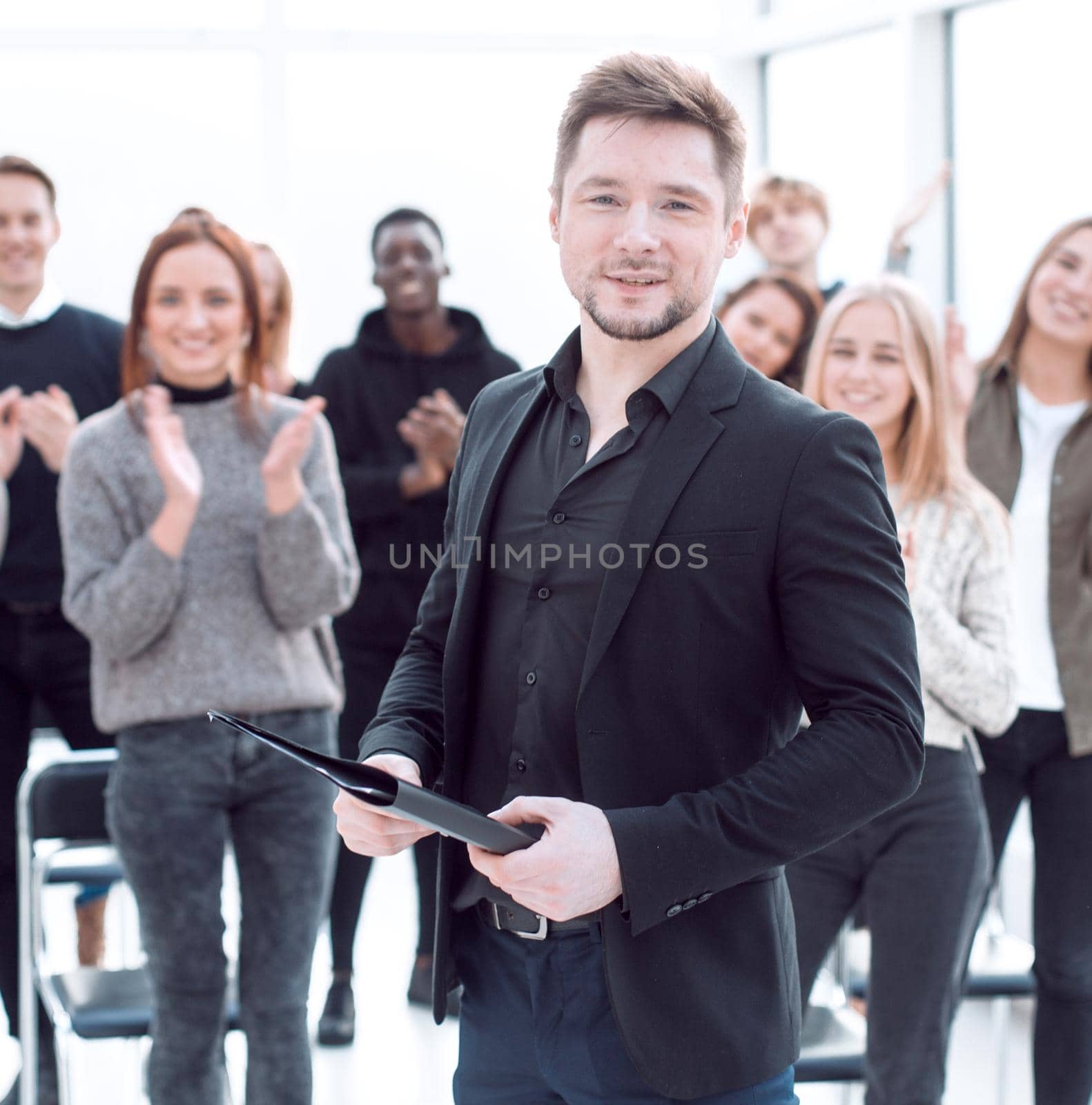 speaker and a group of young listeners standing in a conference room. business and education