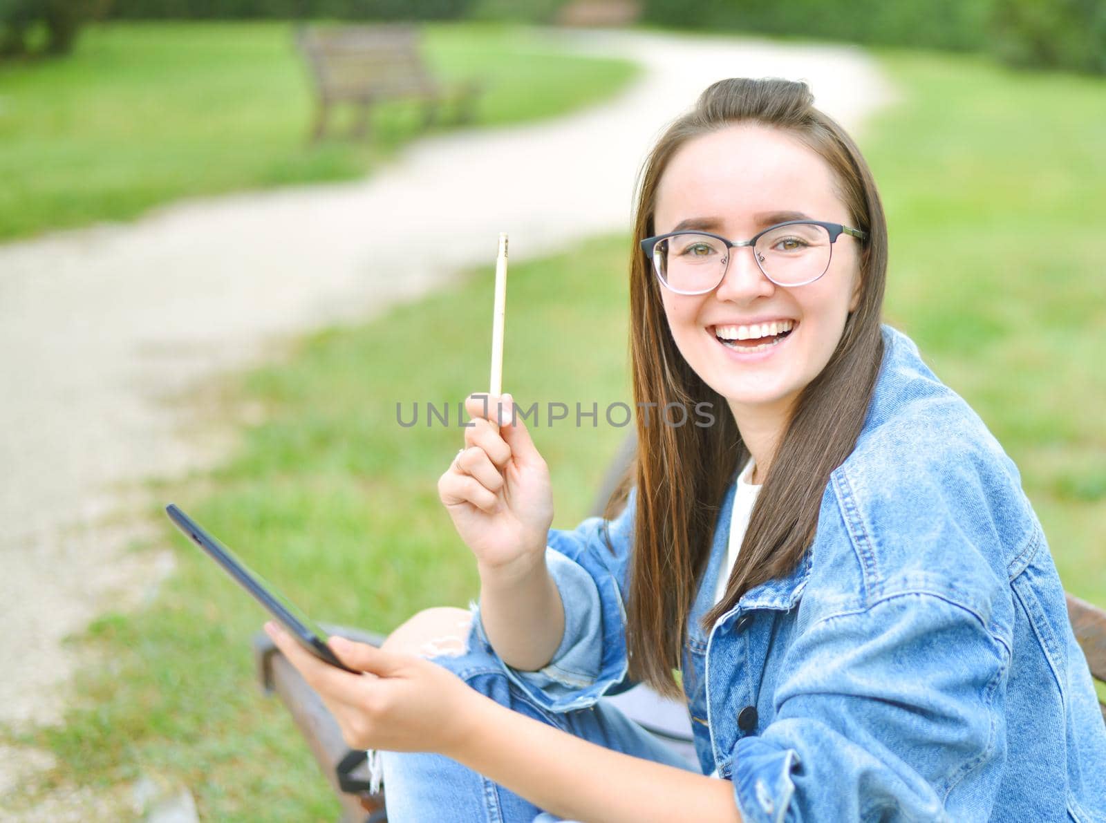 young beautiful student girl is learning outdoor. High quality photo