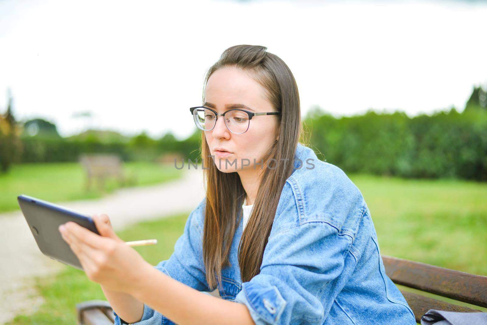 young beautiful student girl is learning outdoor. High quality photo