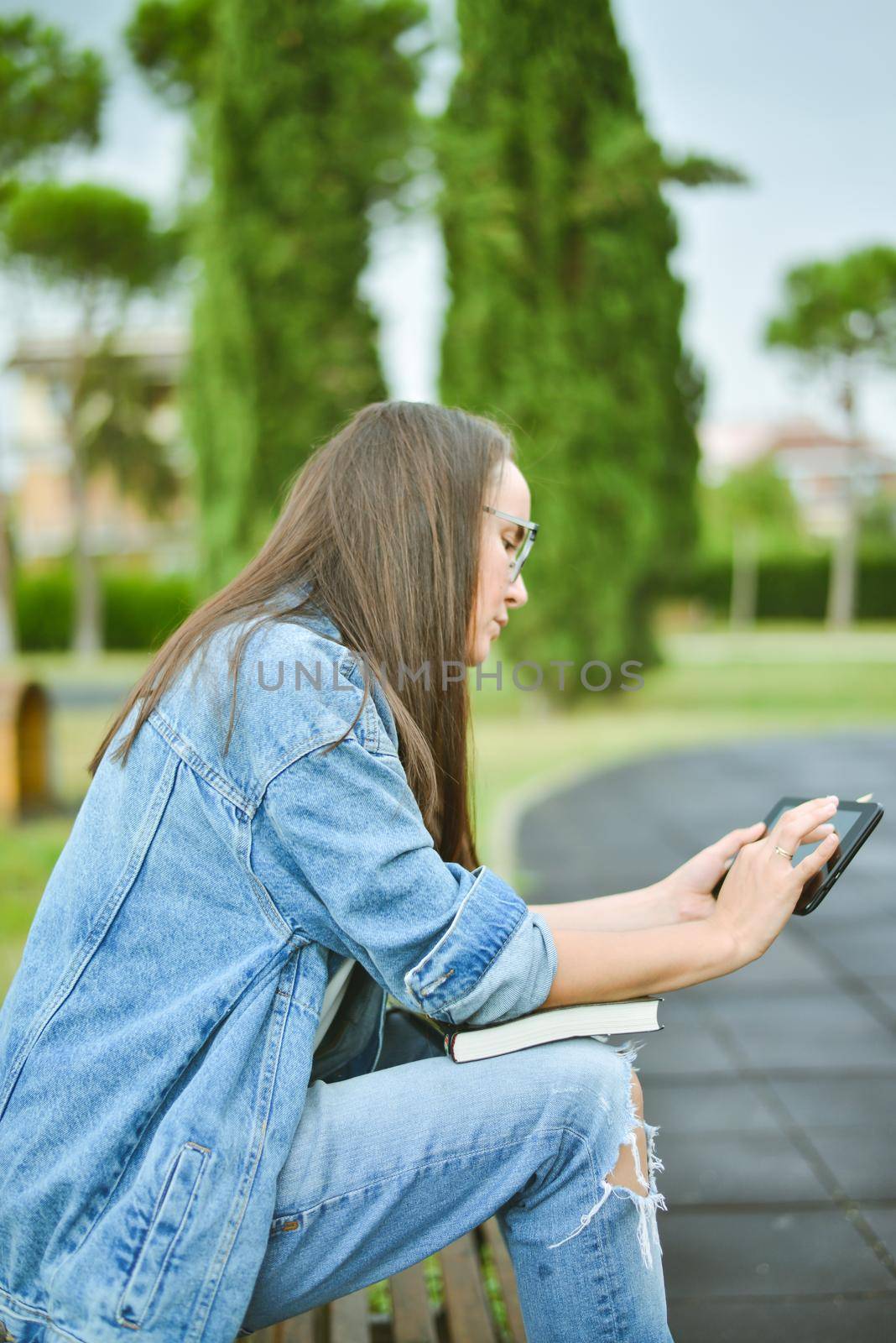 young beautiful student girl is learning outdoor. High quality photo